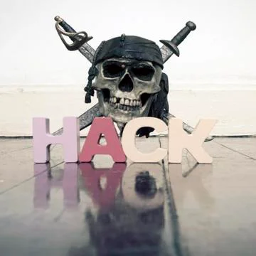 Skull and crossbones with the word HACK on a old wooden floor Stock Photos