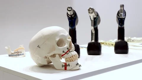 Skull and jaw bone model, medical drill on table Stock Footage 162620842