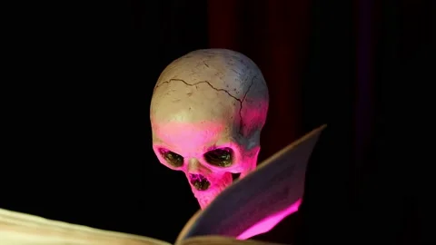 Skull and old open book. The wind turns the pages. Mystic and horror concept Stock Footage 233092364