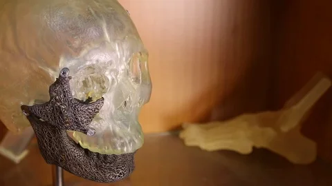 A skull and skeleton of a foot printed in 3D used for medical implants. Stock Footage 81848701