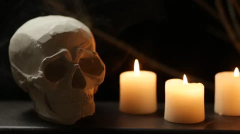 Skull and three candles in mild fume Stock Footage 68052237