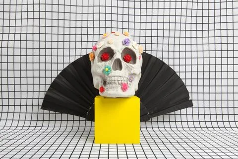 A skull covered with multiple plastic flowers wearing Count Dracula's high-.. Stock Photos