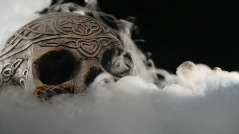 Skull covered in smoke on a dark background Stock Footage 87034095