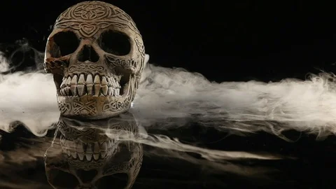Skull covered in smoke on a dark background Stock Footage 87442211