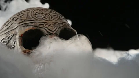 Skull covered in smoke on a dark background Stock Footage 87685471