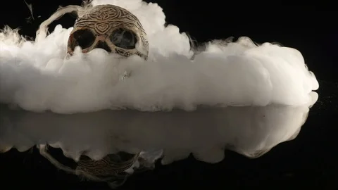 Skull covered in smoke on a dark background Stock Footage 87686552