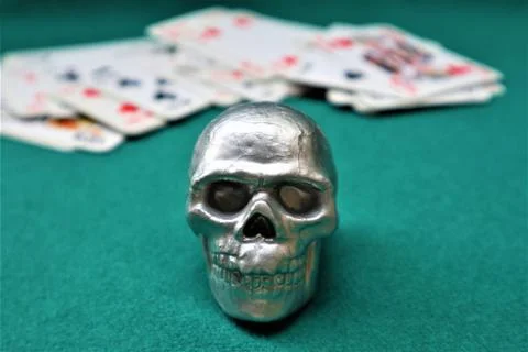 Skull, deck of cards  on a green table. casino table Stock Photos