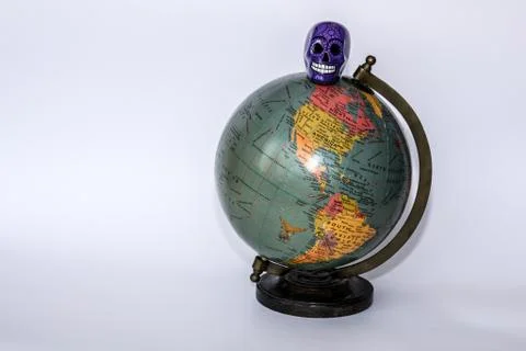 Skull on a globe Stock Photos
