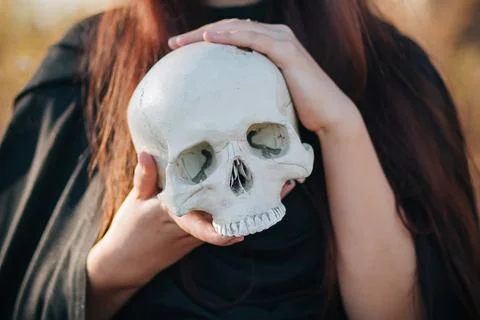Skull in the hands close up. Witchcraft, necromancy. The concept of Halloween Stock Photos