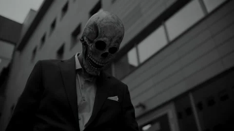 Skull Head Man in a Suit looking down Stock Footage 259885686