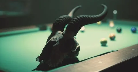 Skull with horns on a pool table surrounded by colorful billiard balls イラスト素材