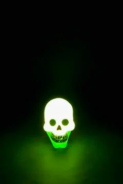 A skull illuminated in green light Stock Photos