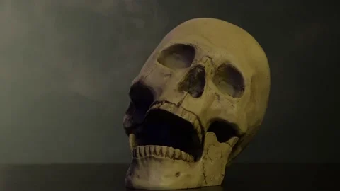 The skull of a man in the smoke screams Video stock 156796109