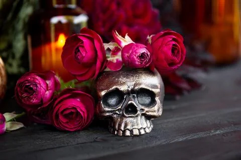 Skull with red roses on dark table, Halloween concept card Stock Photos