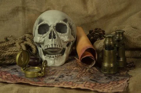 Skull represents the risks of adventure and explorations. Stock Photos
