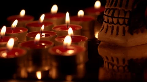 Skull with rose reflection lit with red candles in darkness Stock Footage 114230966