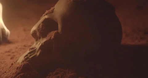 Skull in sand cave with fire Stock Footage 147145579