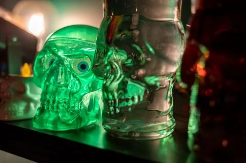 Skull-shaped lantern and bottle displayed on shelf as Halloween decoration Fotos Stock