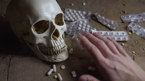 Skull, tablets and hand of a dead person 스톡 동영상 83005776