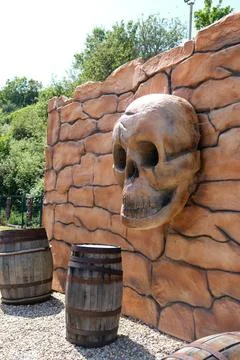 Skull on the wall with barrels Stock Photos