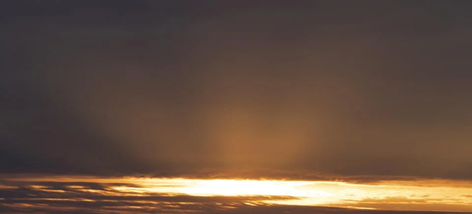 Sky 16: 9, sunset with rays under the clouds Stock Photos