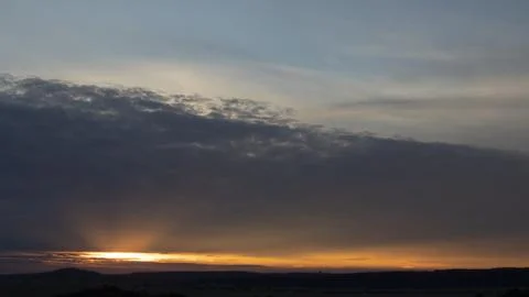 Sky 16: 9, sunset with rays under the clouds Stock Photos