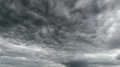 The sky above is filled with dramatic overcast conditions, featuring dark and th Stock Footage 309411262