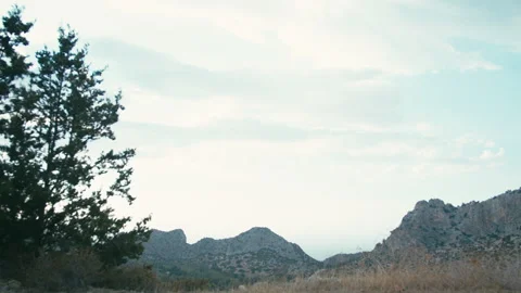 The sky above the mountains, the breeze rustling the trees Stock Footage 328586072