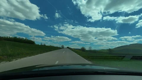 Sky above is vivid blue with soft white clouds. Balkan, Eastern Europe, POV Video stock 333586926