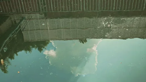 Sky and Building Reflection on Rippling Murky Water Surface in City Canal Stock Footage 330517371