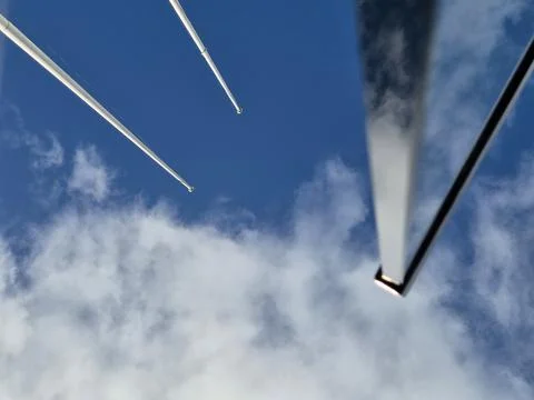 Sky and clouds with airplane engine and contrails Stock Photos