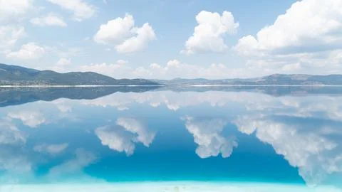 The sky and clouds are reflected in the water of the lake, calm water, smooth Stock Photos