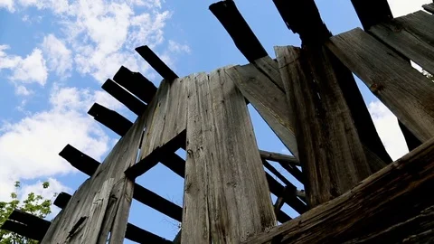 Sky and clouds are visible through the ruined roof of the house Stock Footage 77683594