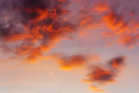 Sky and clouds in bright rainbow colors and smooth red colored sky in twilight Stock Photos