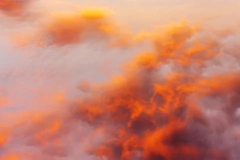 Sky and clouds in bright rainbow colors and smooth red colored sky in twilight Stock Photos