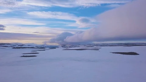 Sky and clouds at dusk in a landscape of snow, aerial shot in Iceland Stock Footage 116108261