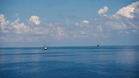 Sky and clouds over sea With Boat On Horizon and offshore platform. Stock Footage 146359078