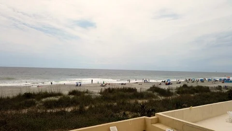 Sky and Clouds with people on the beach timelapse Video stock 107848632