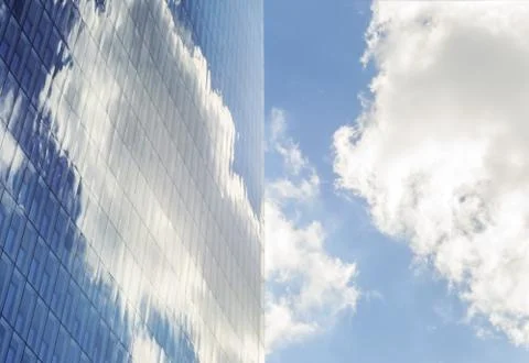 Sky and clouds reflected in windows of modern  tall office building. Stock Photos