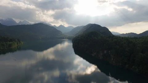 Sky and clouds reflecting on lake with beautiful mountains in background Stock Footage 116185329
