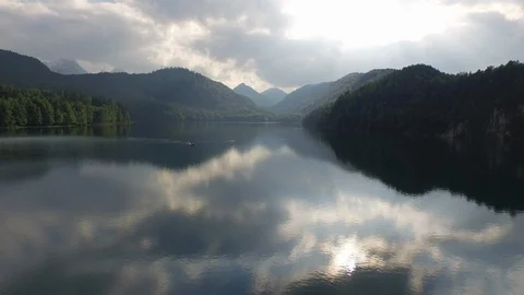 Sky and clouds reflecting on lake with beautiful mountains in background Stock Footage 116185443