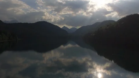 Sky and clouds reflecting on lake Alpsee with beautiful mountains in background Stock Footage 116186557