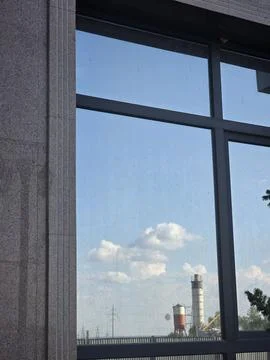 Sky and clouds reflection in office window glass Stock Photos