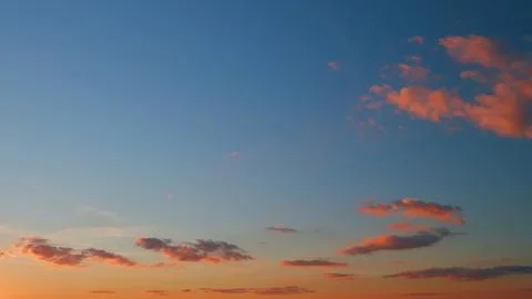 Sky and clouds at sunset. Different shades cloud with color sky. Timelapse. Stock Photos
