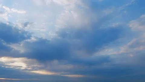 Sky and clouds at sunset. Different shades cloud with color sky. Timelapse. Stock Photos