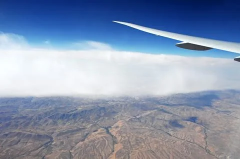 Sky and clouds Through Flight Window Stock Photos