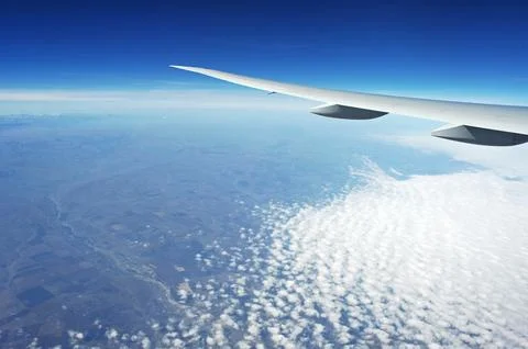 Sky and clouds Through Flight Window Stock Photos