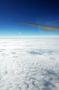 Sky and clouds Through Flight Window Stock Photos