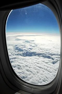 Sky and clouds Through Flight Window Stock Photos
