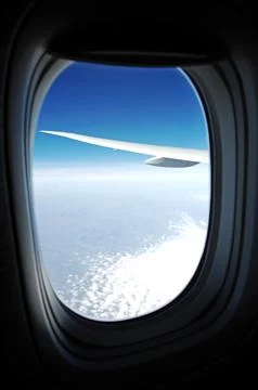 Sky and clouds Through Flight Window Stock Photos